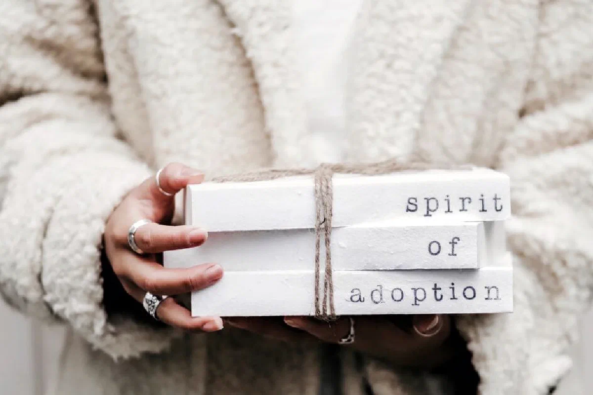 What does it mean that Christians are adopted by God?