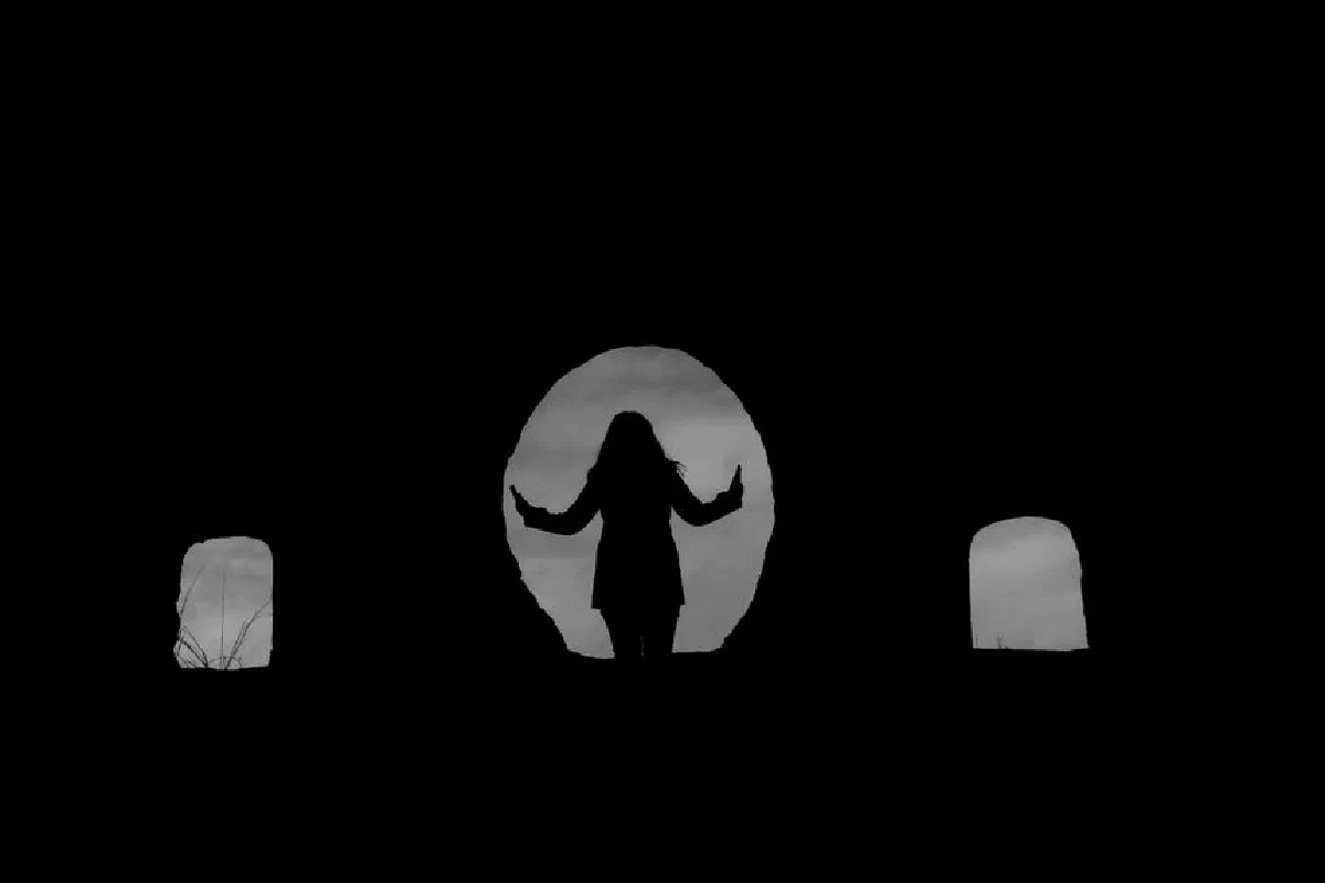 Silhouette of a woman standing in a stone archway, creating a mysterious and captivating scene.