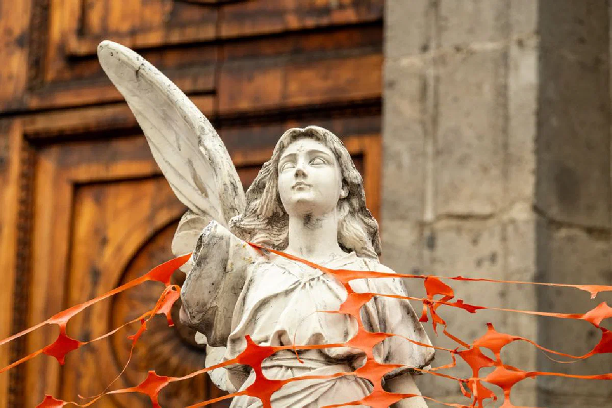 Statue of an angel in Mexico City, surrounded by construction netting.