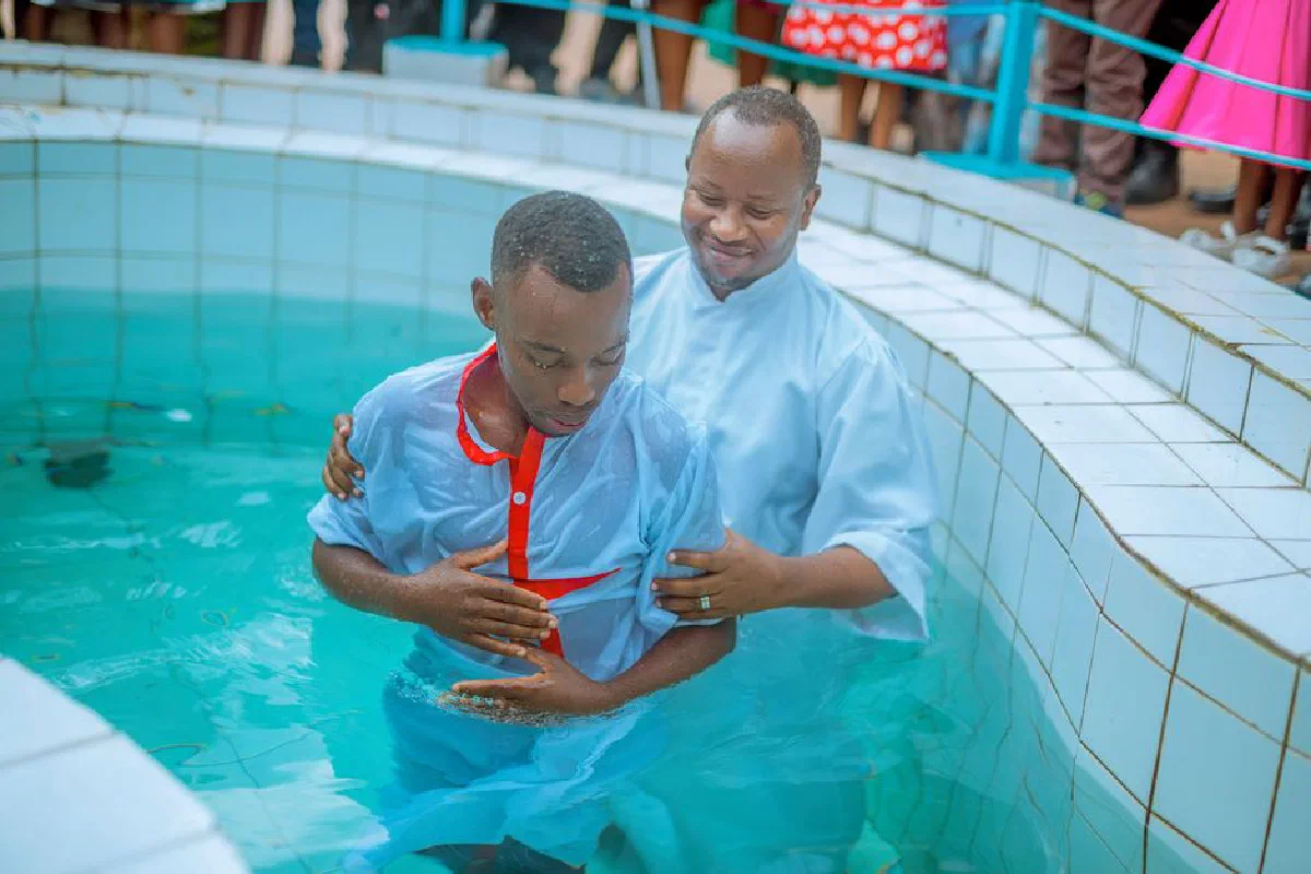 Baptism ceremony with two men in a swimming pool, symbolizing faith and spirituality.