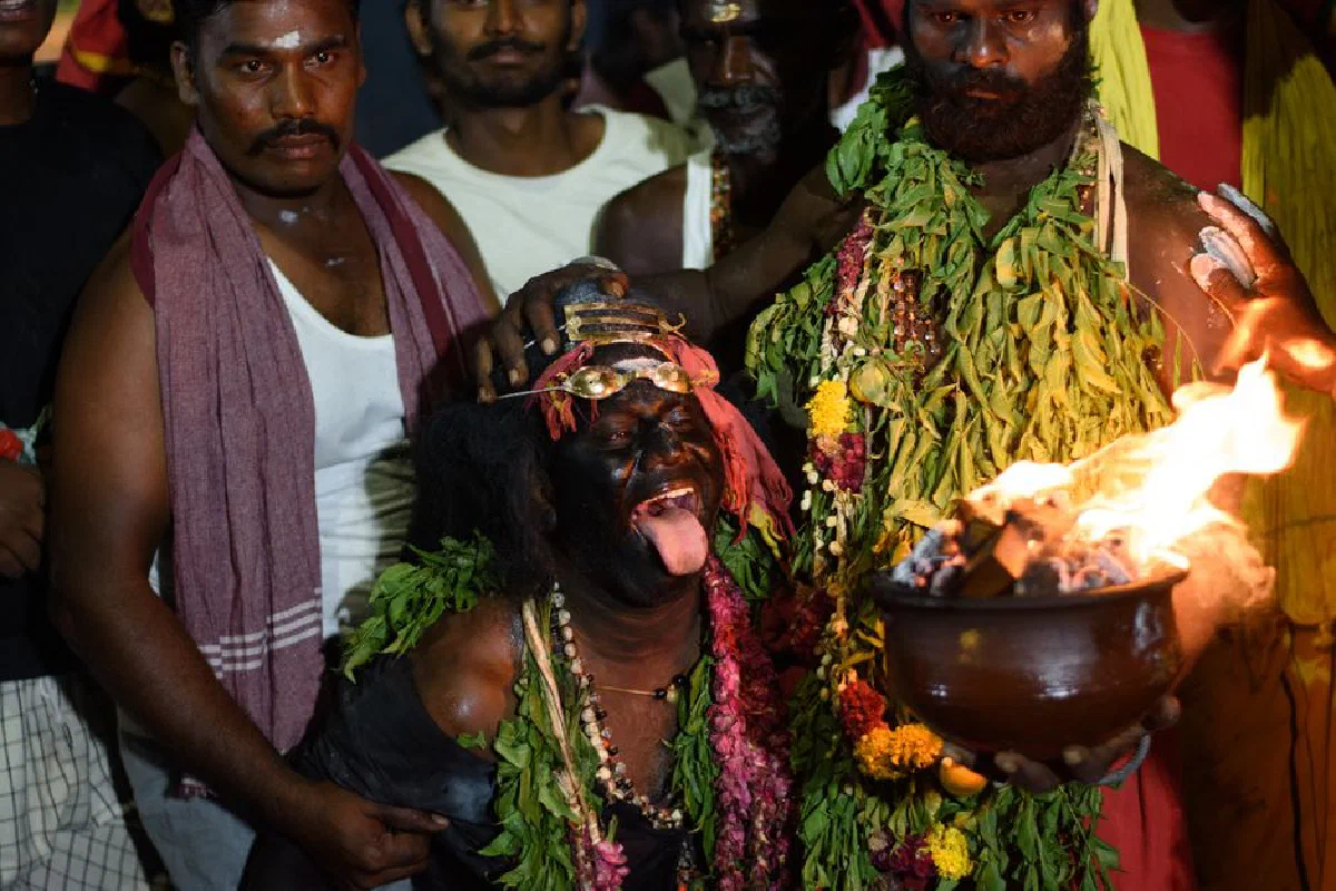 A dynamic night scene of a traditional ritual in Kulasekharapatnam, India, showcasing cultural expressions.