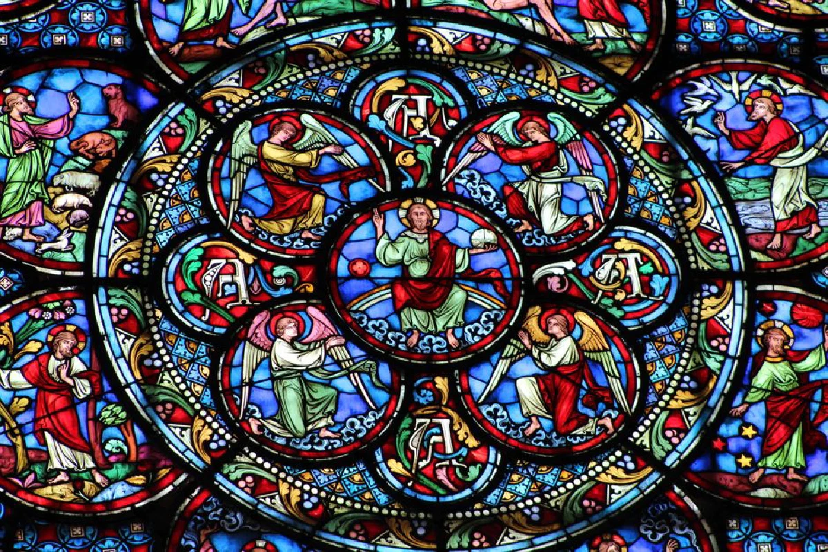 Vibrant stained glass window depicting biblical scenes and figures in a church.