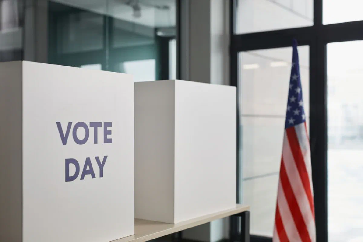 Voting booth setup with American flag, symbolizing election day.