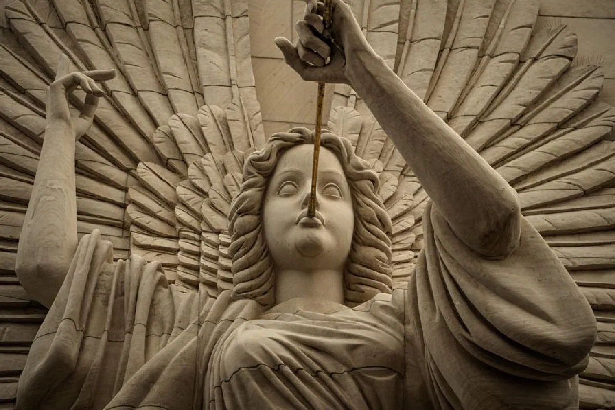 Majestic stone angel sculpture with wings in a classic artistic style.