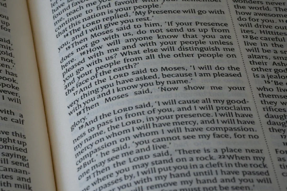 A detailed close-up of an open Bible showing text from the Book of Exodus.