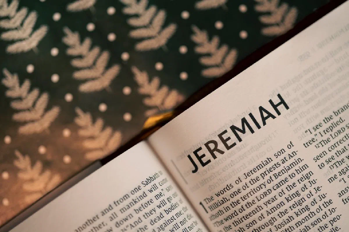 Close-up of the Book of Jeremiah in an open Bible with patterned background.