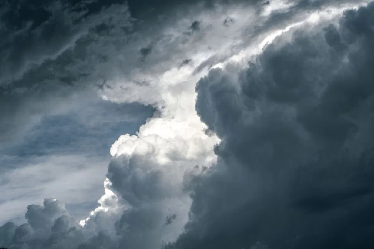 Captivating image of dramatic clouds with contrasting dark and light tones, creating a moody sky.