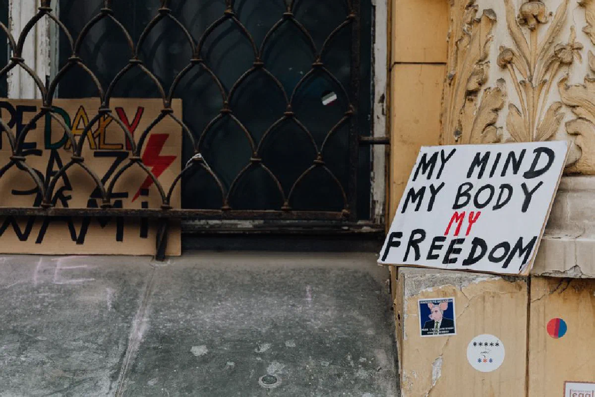Protest signs advocating freedom and choice placed outside a historic building facade.