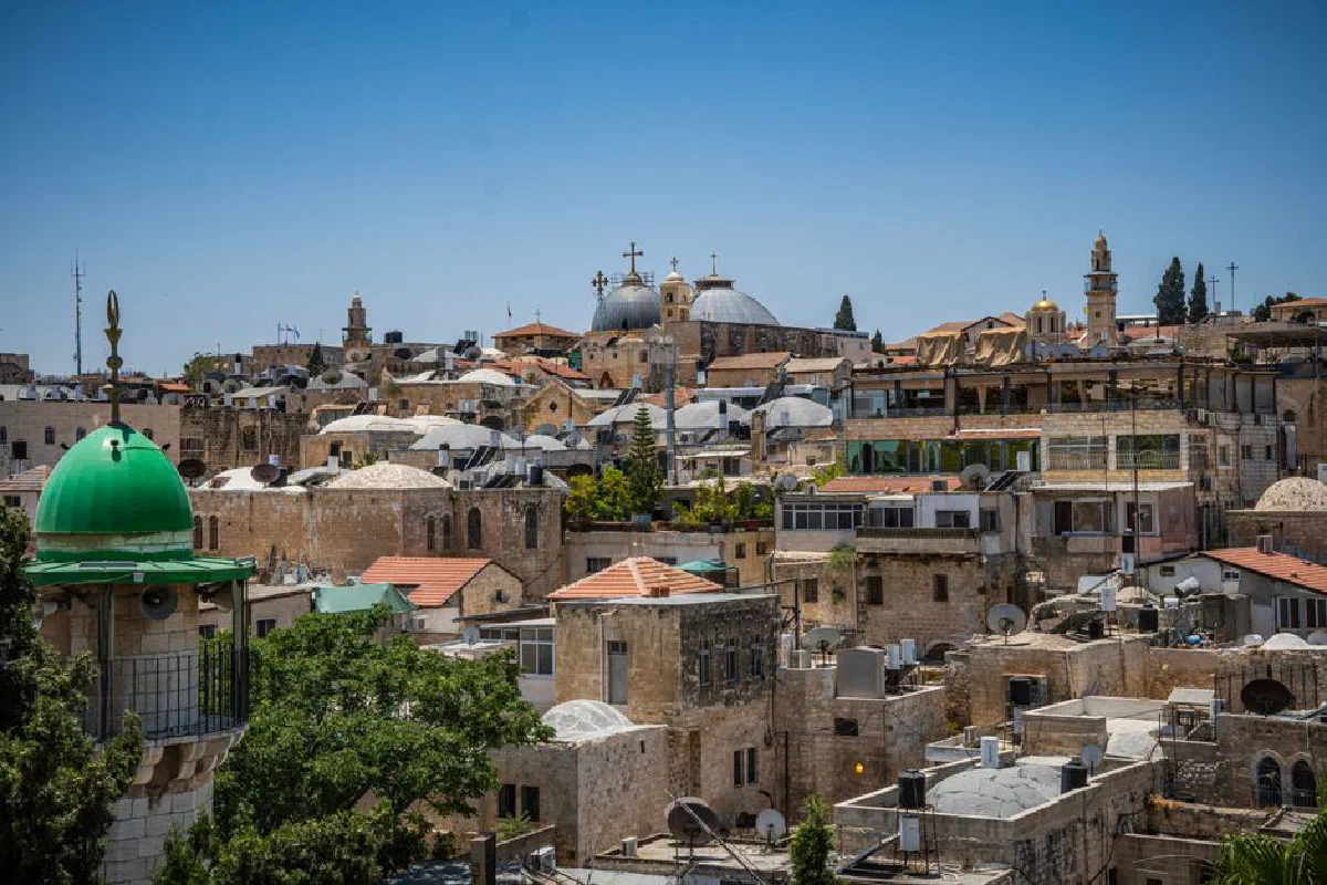 A vibrant view of Jerusalem's ancient architecture under a clear blue sky.