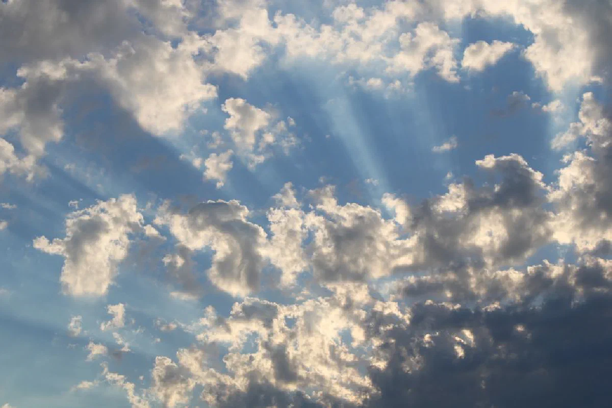 Beautiful scattered clouds with sunrays in a blue sky, captured in Saltum, Denmark.