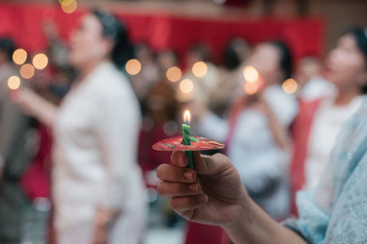 A serene church service with candle lighting during worship, creating a spiritual ambiance.