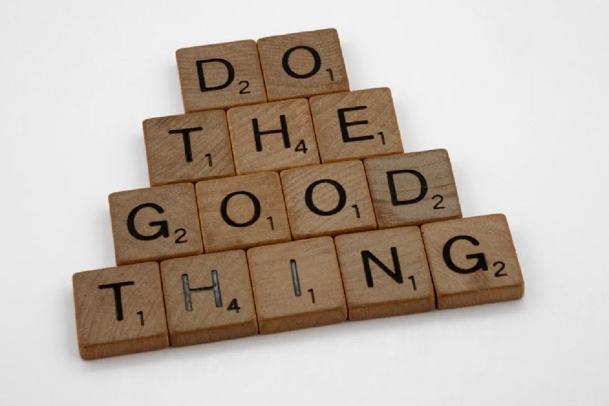 Wooden tiles arranged to spell 'Do The Good Thing,' promoting positive action.