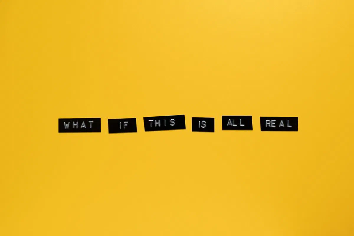 Minimalist text on vibrant yellow backdrop reading 'What if this is all real.'