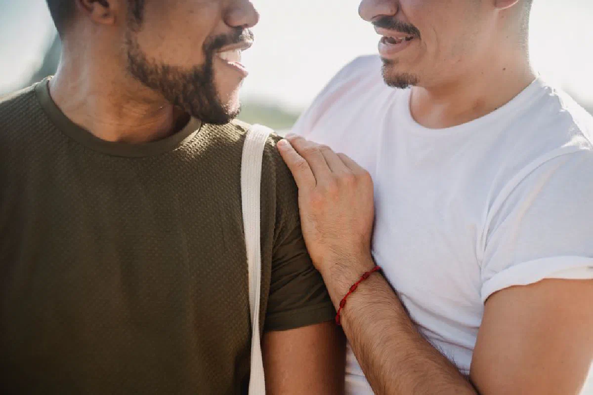 A warm moment between an interracial couple enjoying time together outdoors.