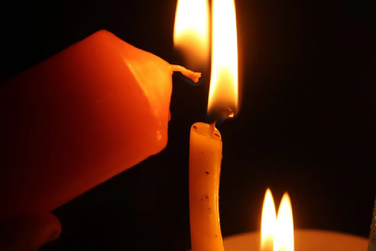 Warm glow of lit candles creating a serene ambience against a dark background.