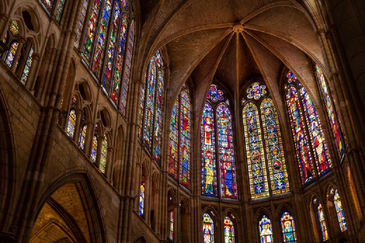 Intricate stained glass windows in the Gothic cathedral of León, Spain.