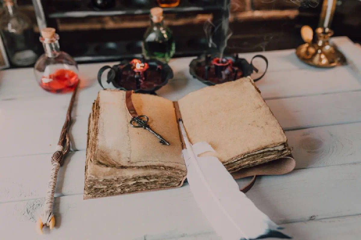 Magical setup featuring ancient spellbook, wand, and potions, creating a mystical atmosphere.