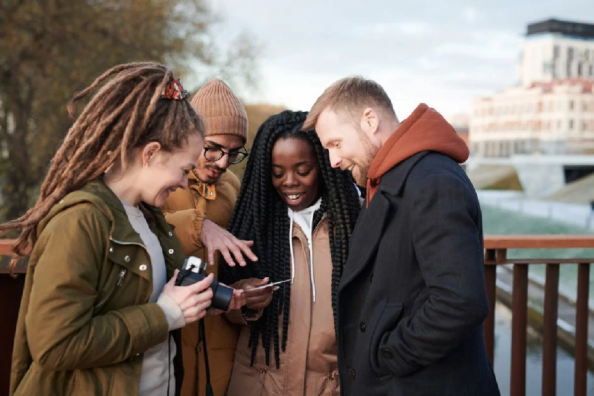 Friends sharing a moment outdoors in winter attire, smiling and happy.