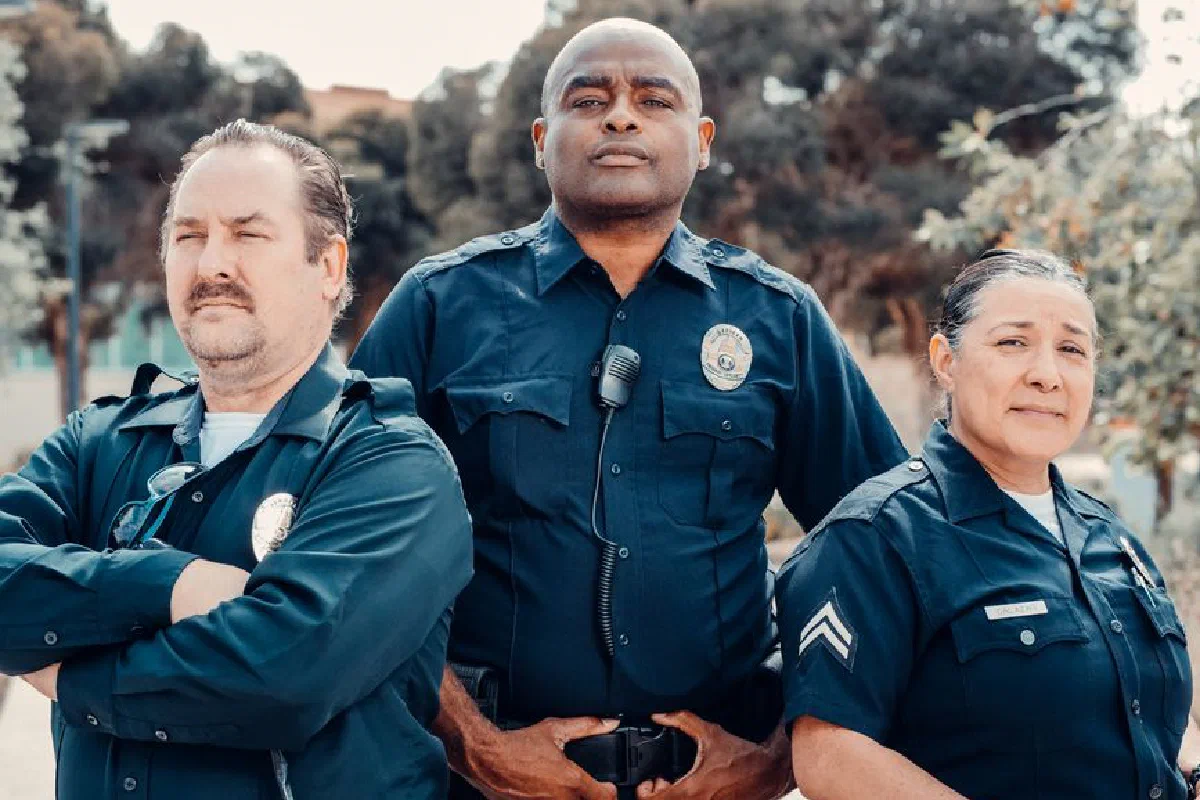 Group of diverse police officers posing outdoors, emphasizing unity and public safety.