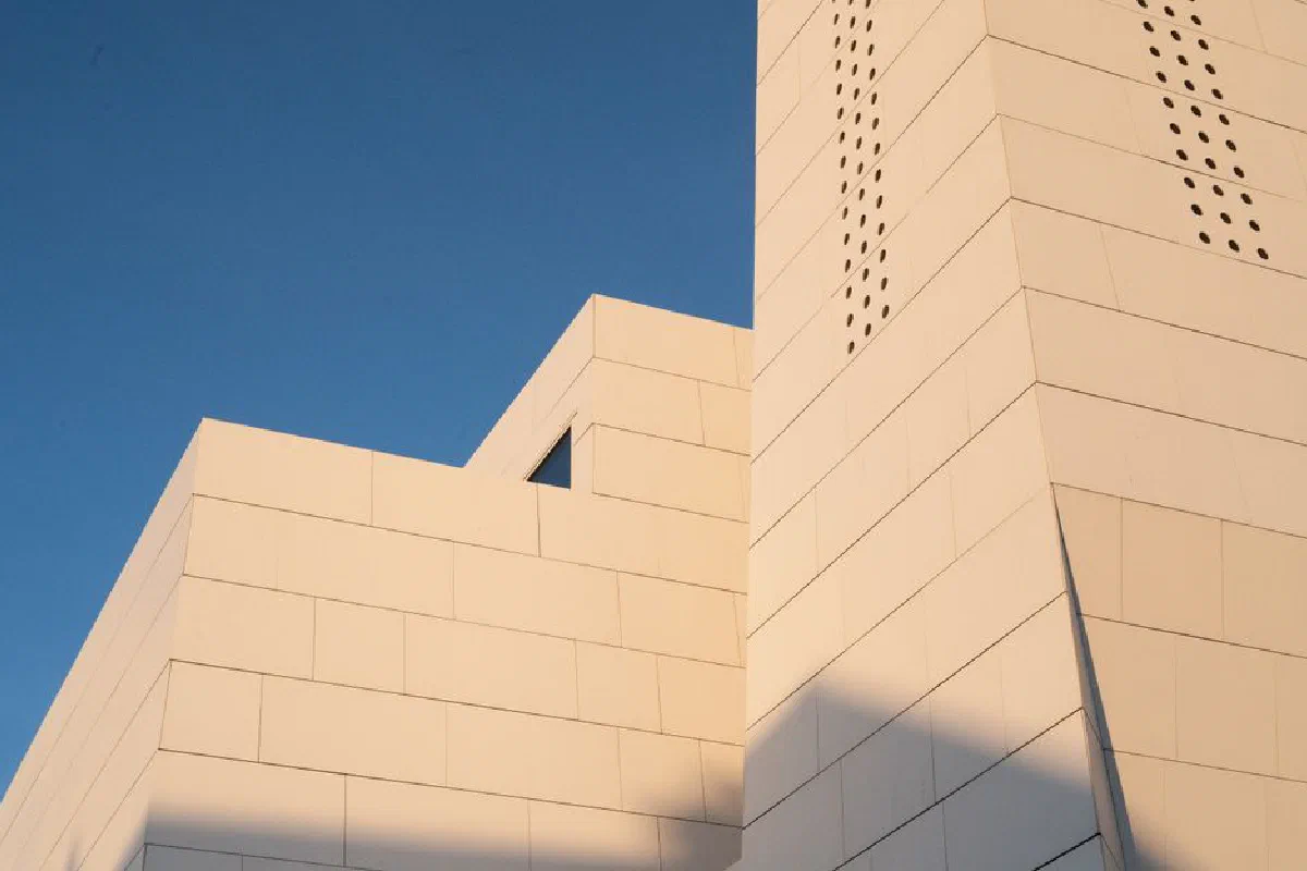 Minimalist architectural design captured in warm daylight against a clear sky in Norway.