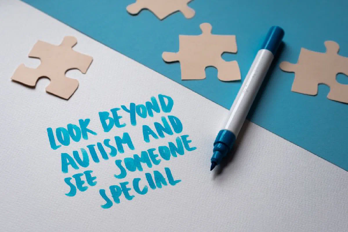 Inspirational autism awareness message with puzzle pieces and handwritten text.