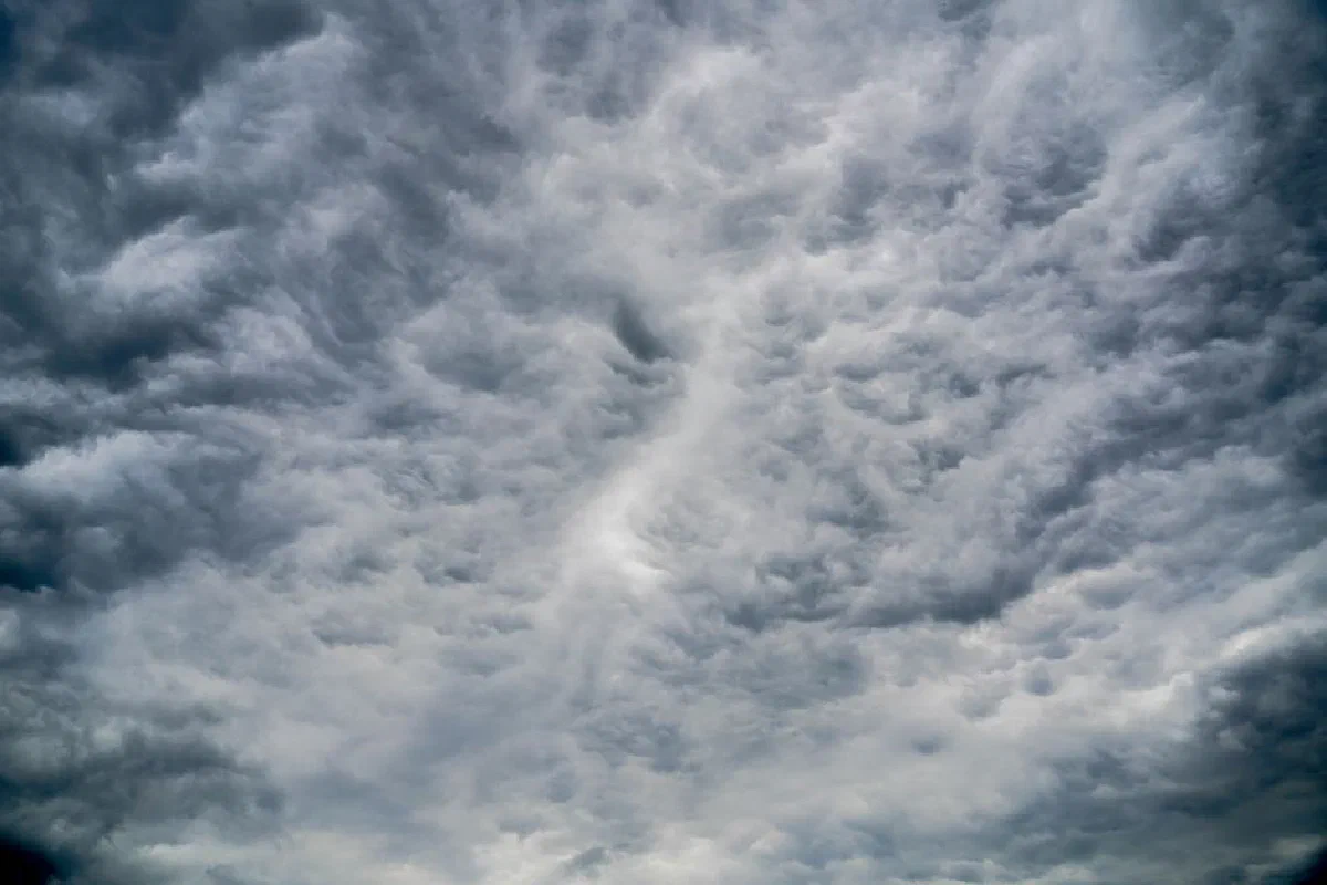 A stunning view of dramatic cumulus clouds filling the sky, showcasing dynamic weather patterns.