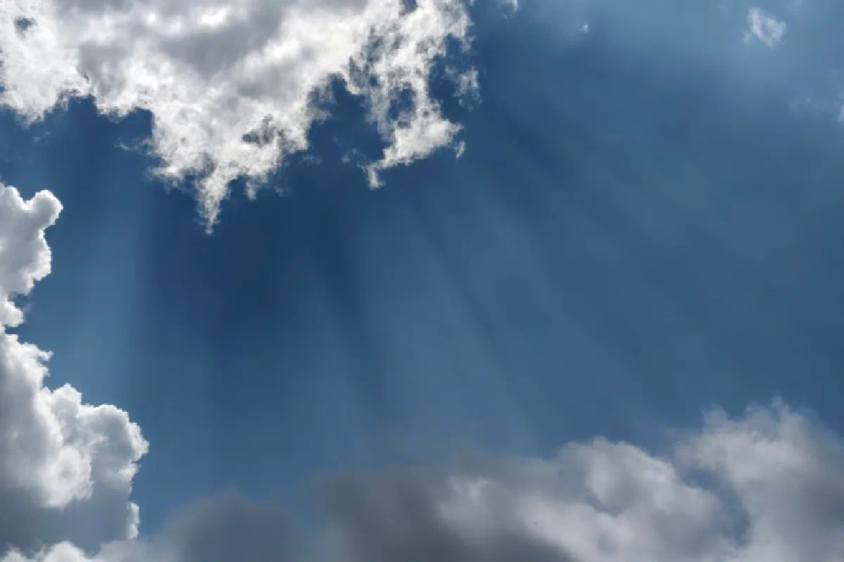 Beautiful sunlight beams through textured clouds, creating a dramatic sky scene over Silchar, India.
