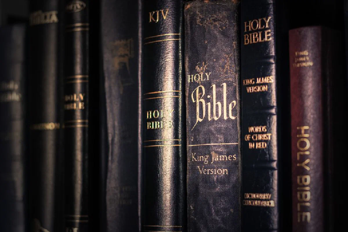 A detailed view of various King James Version Bibles, highlighting religious imagery.