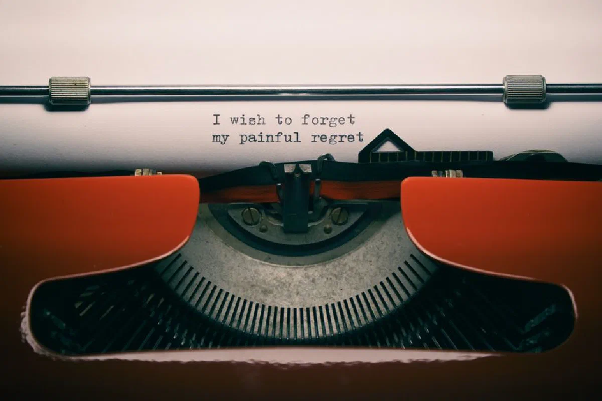 Close-up of a vintage typewriter with melancholic quote, perfect for reflective concepts.