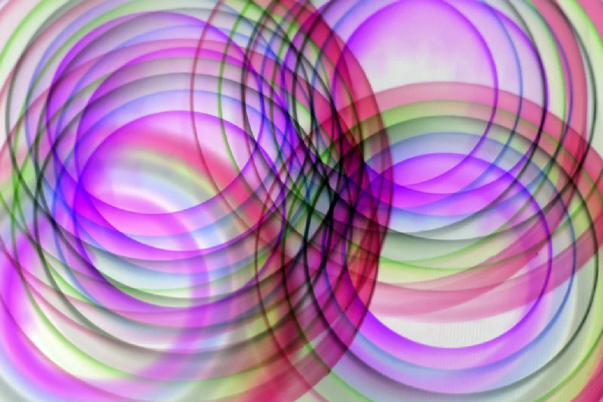 Vibrant abstract circular pattern with overlapping hues of pink, green, and purple.