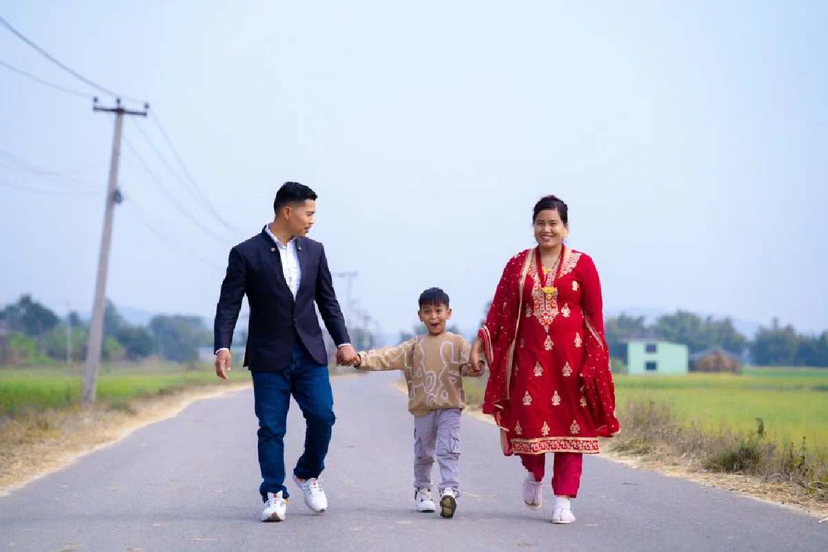 Family enjoying a walk down a scenic countryside road, showcasing joy and togetherness.