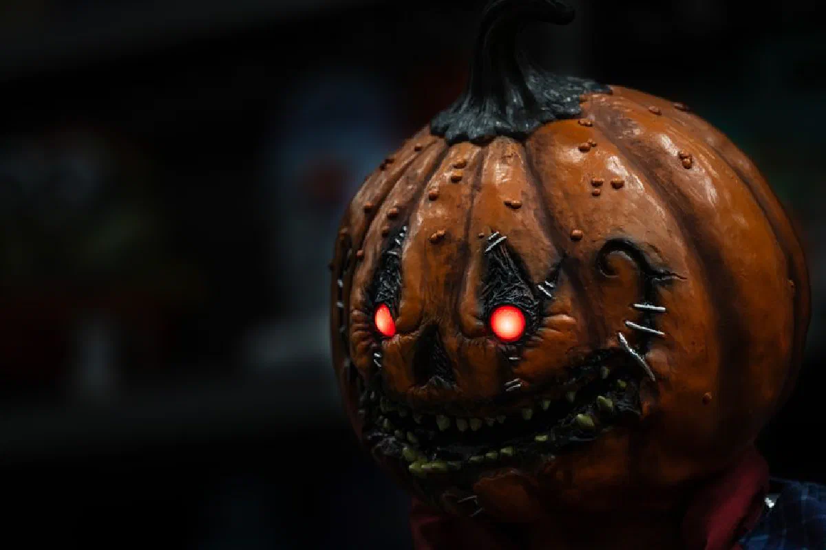 Dark and eerie pumpkin head with glowing eyes perfect for Halloween horror theme.