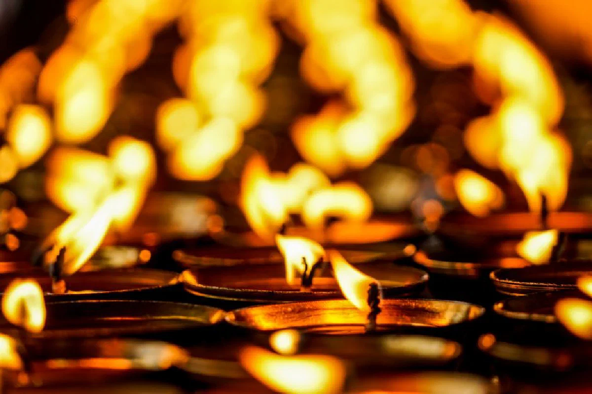Captivating close-up of lit candles with vibrant bokeh effect in Thimphu, Bhutan.