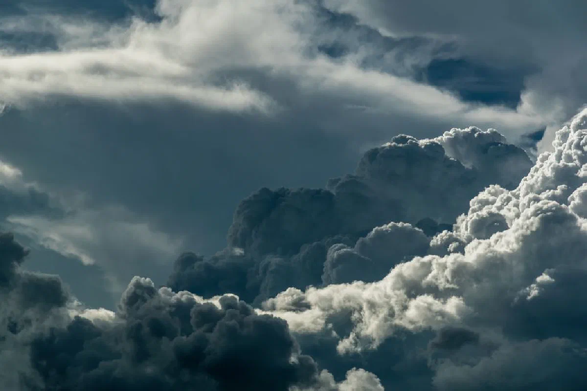 A powerful depiction of dark, dramatic clouds covering the sky, showcasing the majestic beauty of nature.