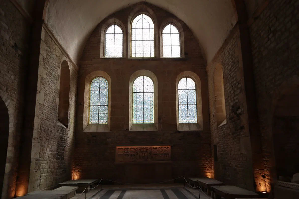 Historic abbey in Montbard, France, showcasing medieval stone architecture and stained glass windows.