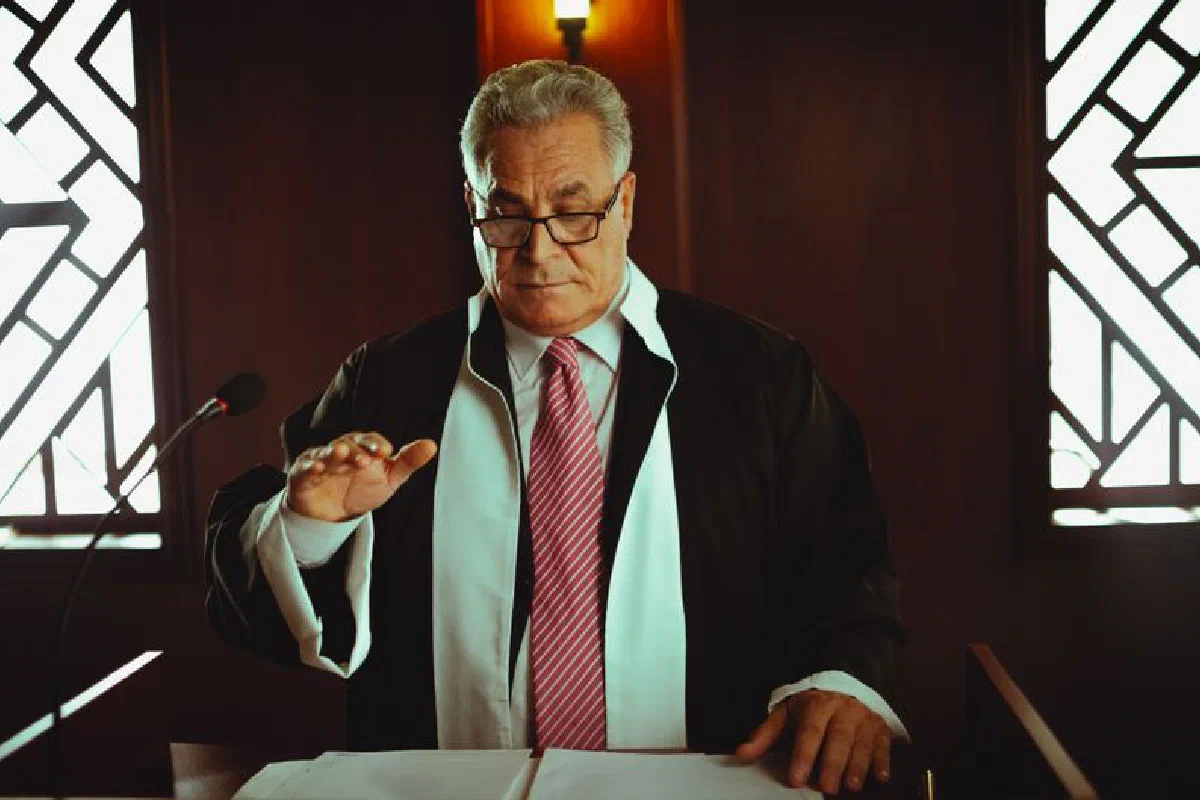 Mature male judge in a courtroom taking an oath, Baghdad, Iraq.