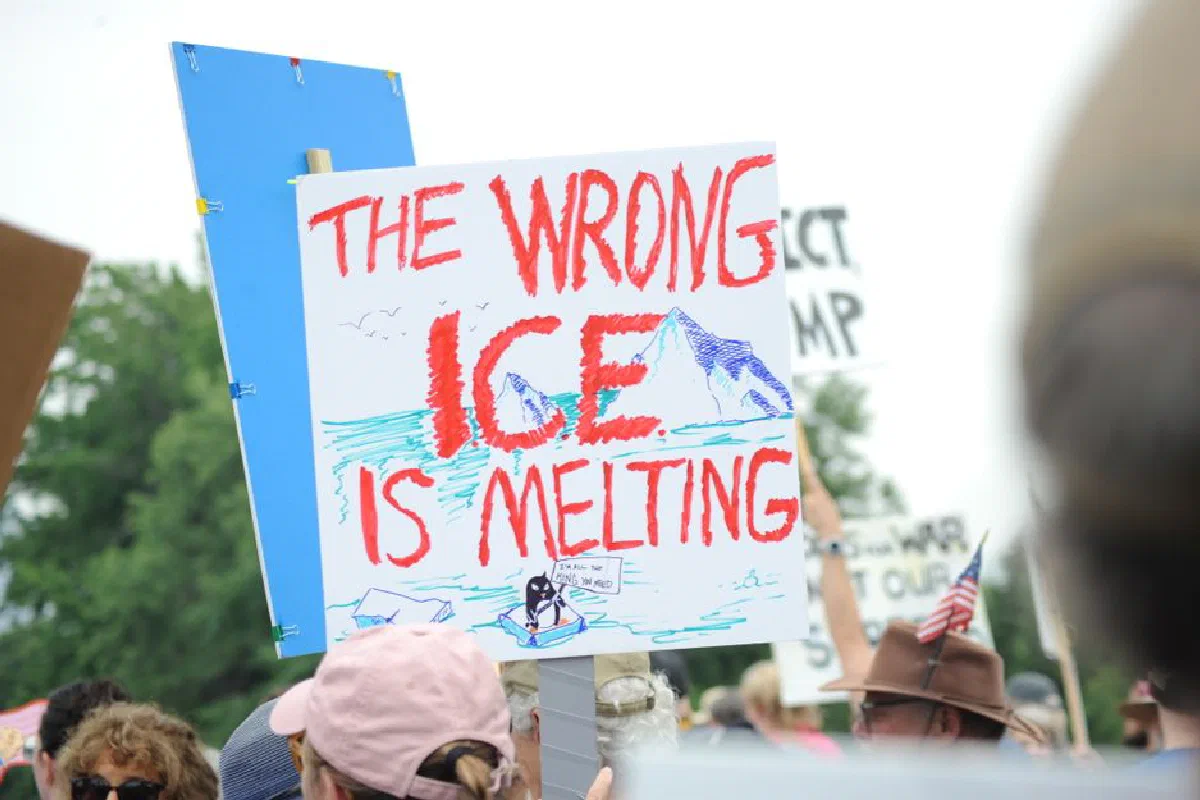 Protesters in Baltimore hold signs about climate change, highlighting melting glaciers.