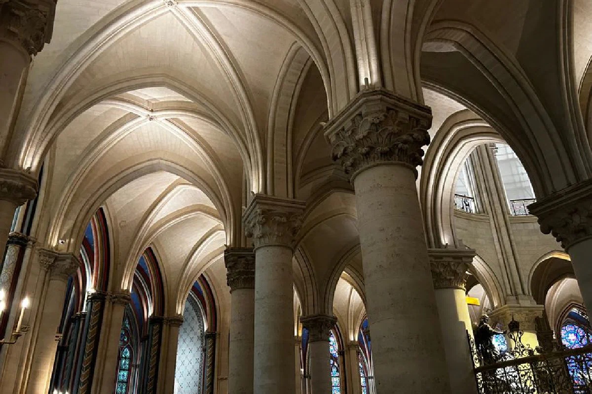 Intricate Gothic arches inside a historic Paris cathedral showcasing stunning architecture.