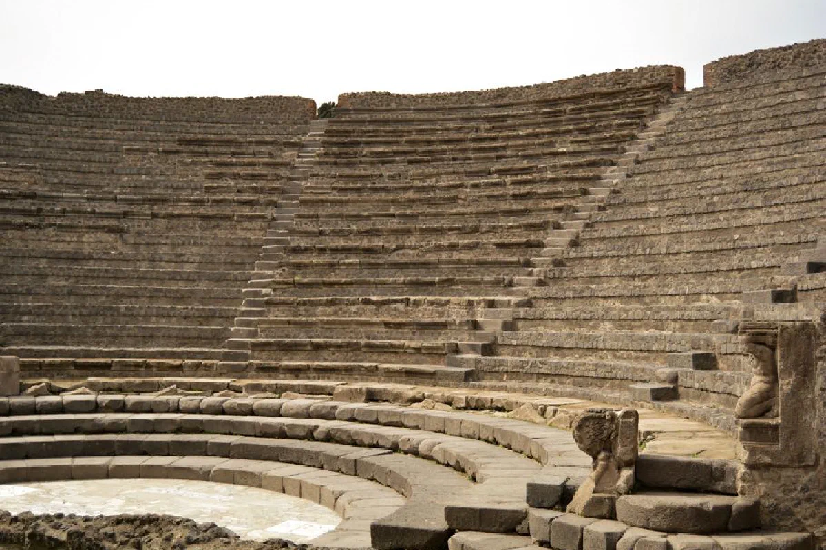 Ancient Roman amphitheater ruins showcasing stone seating under daylight.