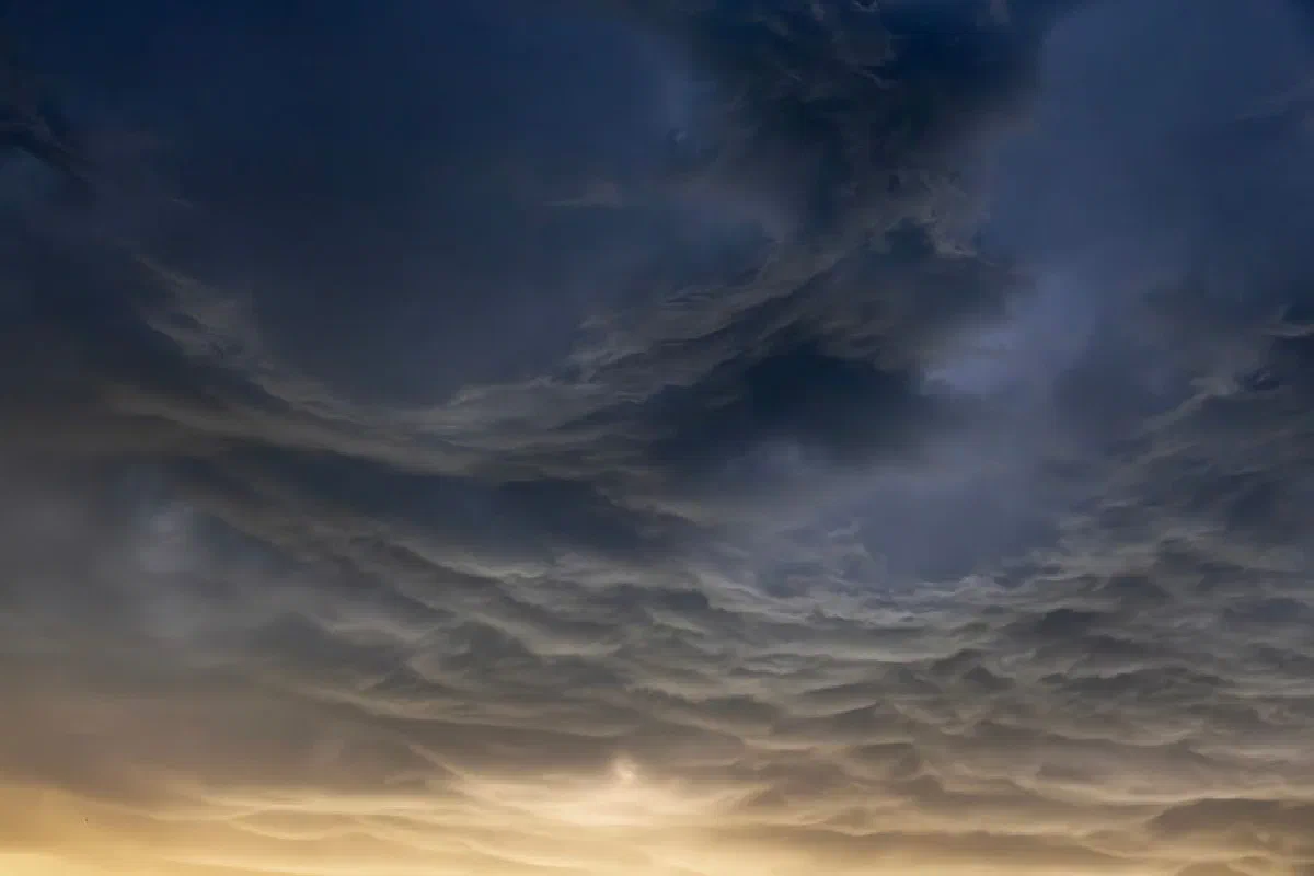 A breathtaking view of storm clouds creating a dramatic sky over Almaty at sunset. Perfect for backgrounds and nature enthusiasts.