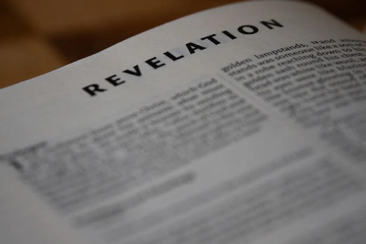 A close-up shot of the Book of Revelation from the Bible, emphasizing text.