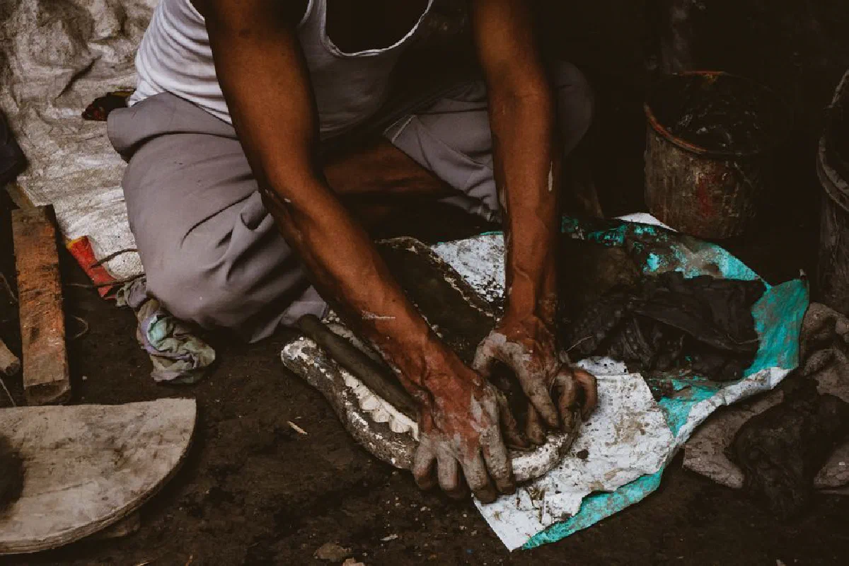 South Asian artisan molds clay by hand, showcasing traditional craftsmanship in Kolkata.