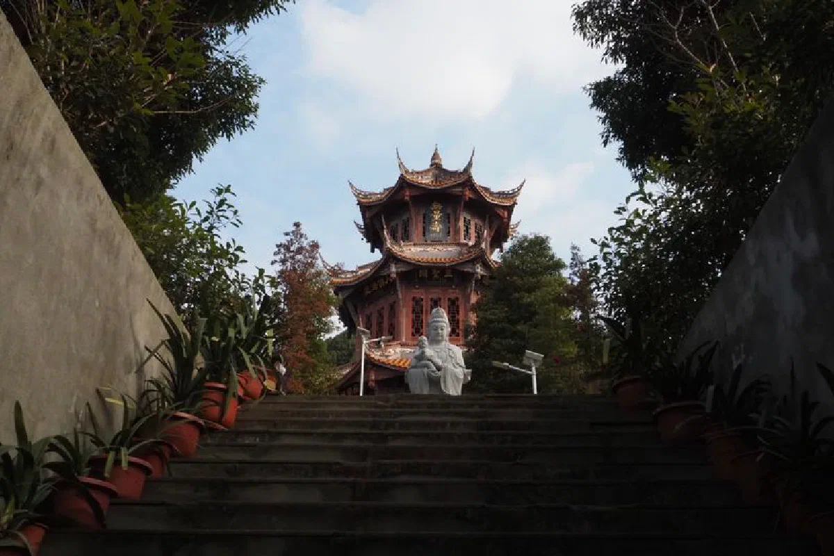 Discover the serene beauty of a Buddhist temple and statue at Zhaojue Temple in Chengdu, China.