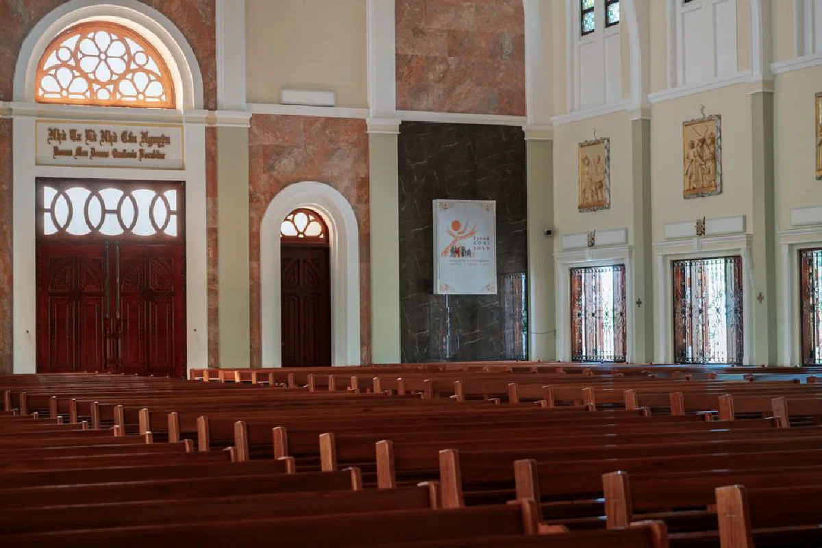 A serene empty church interior showcasing arches and elegant wooden pews, ideal for religious spirituality themes.