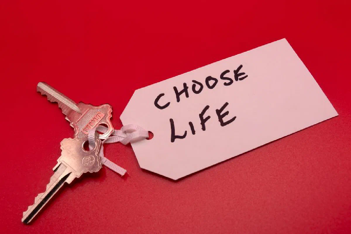 Keys on a red background with a 'Choose Life' tag, symbolizing decision-making.