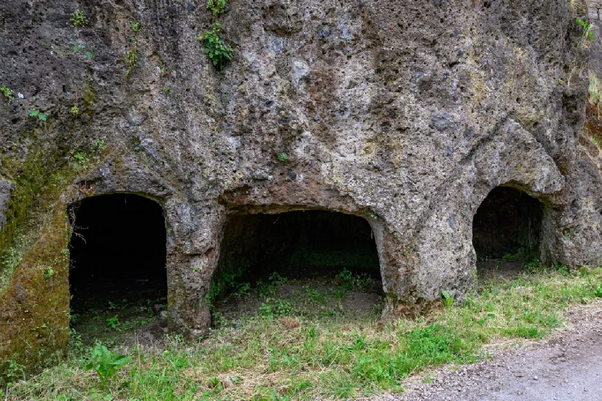 Explore ancient Etruscan tomb carvings in the rocky terrains of Lazio, Italy.