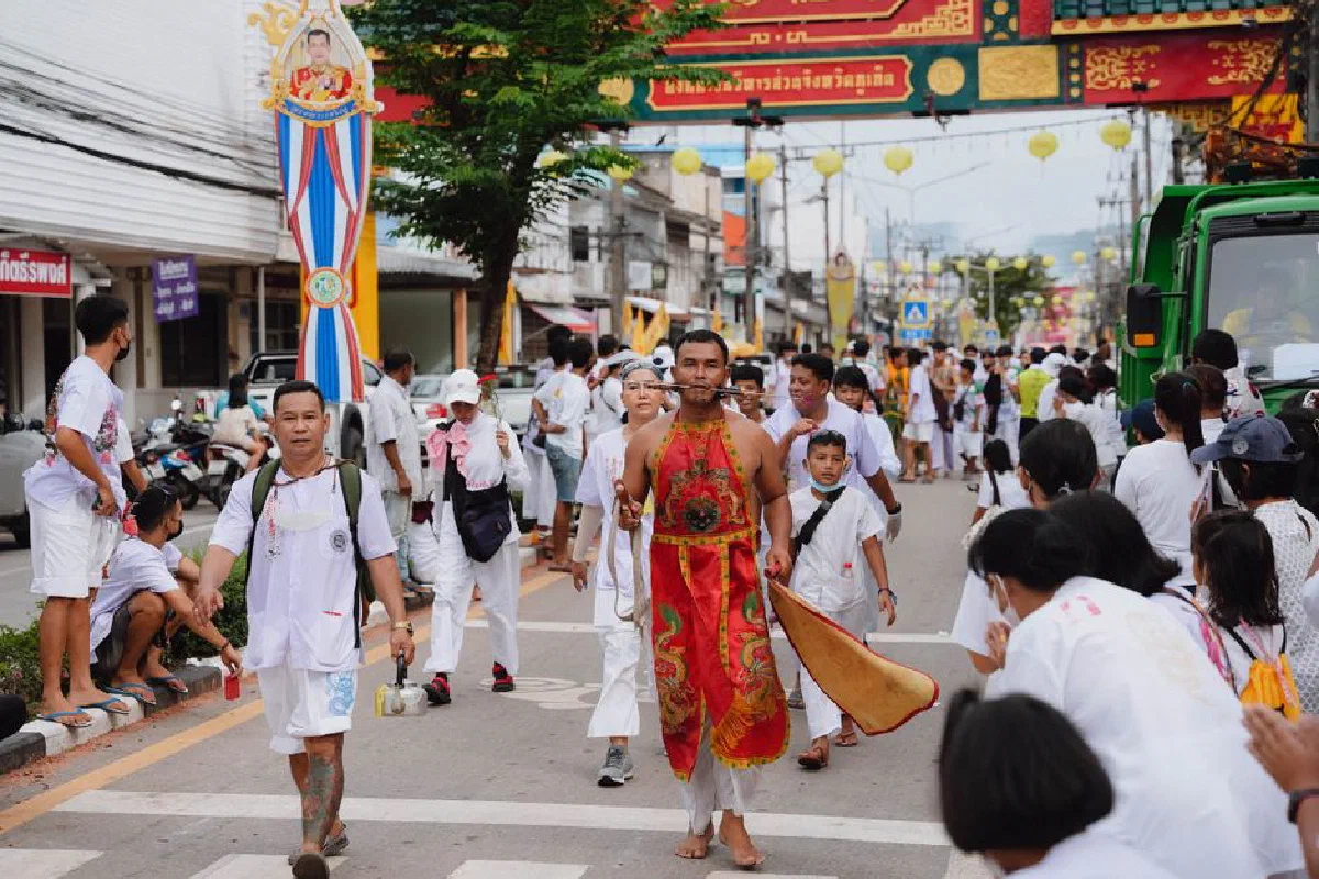 Colorful street parade during a traditional festival in Phuket, Thailand showcasing cultural celebrations.