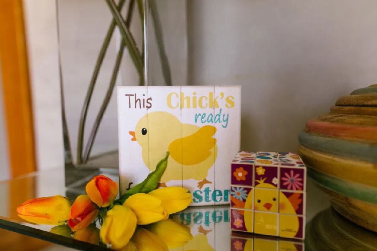Colorful Easter-themed display with a chick card, tulips, and a decorative puzzle cube.