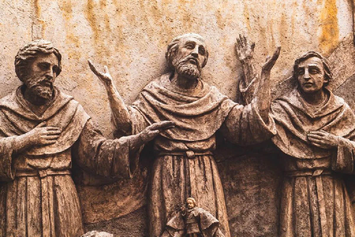 Detailed stone sculpture of monks in prayer, reflecting Renaissance artistry.