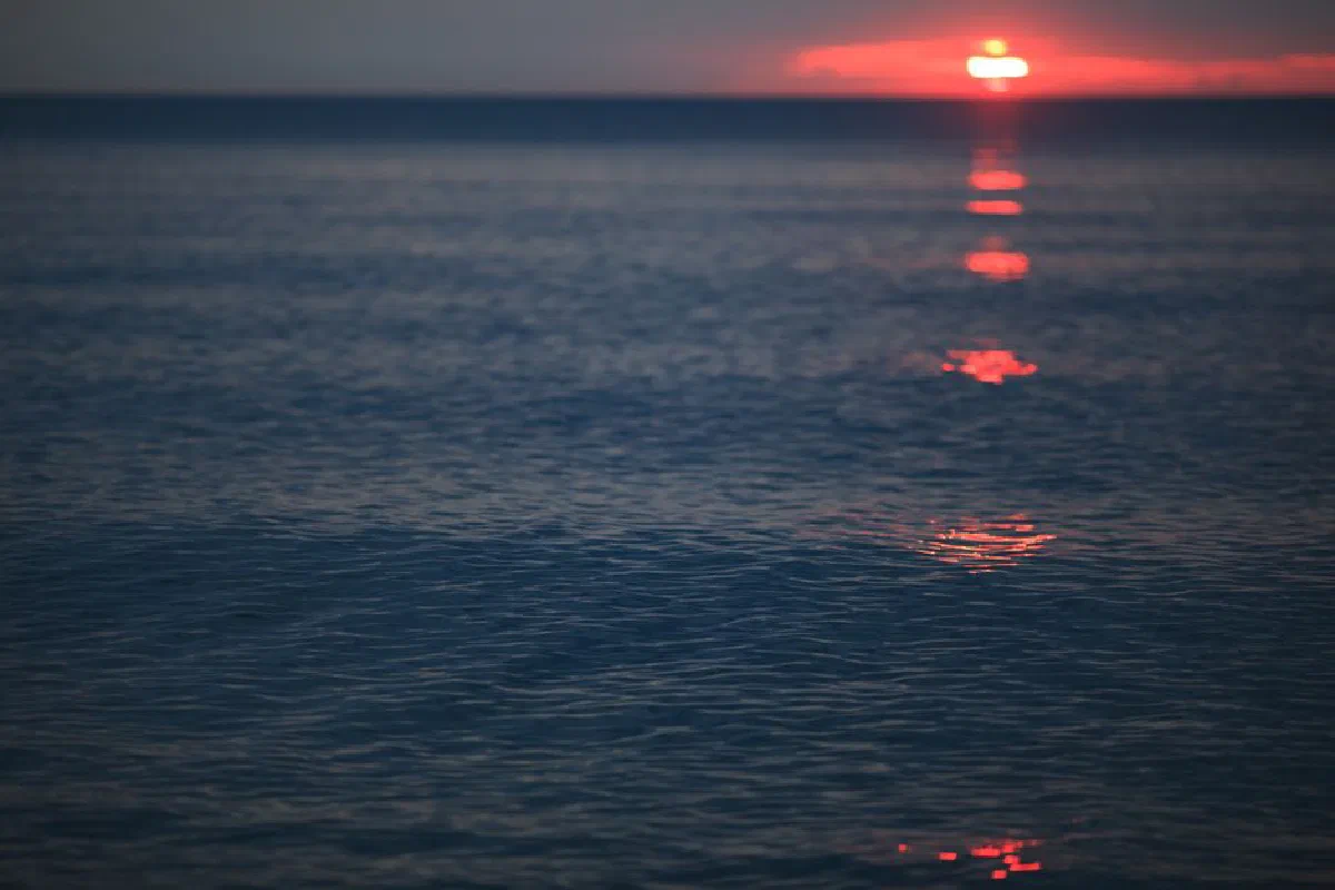 Peaceful ocean view at sunset with beautiful reflections creating a calming mood.